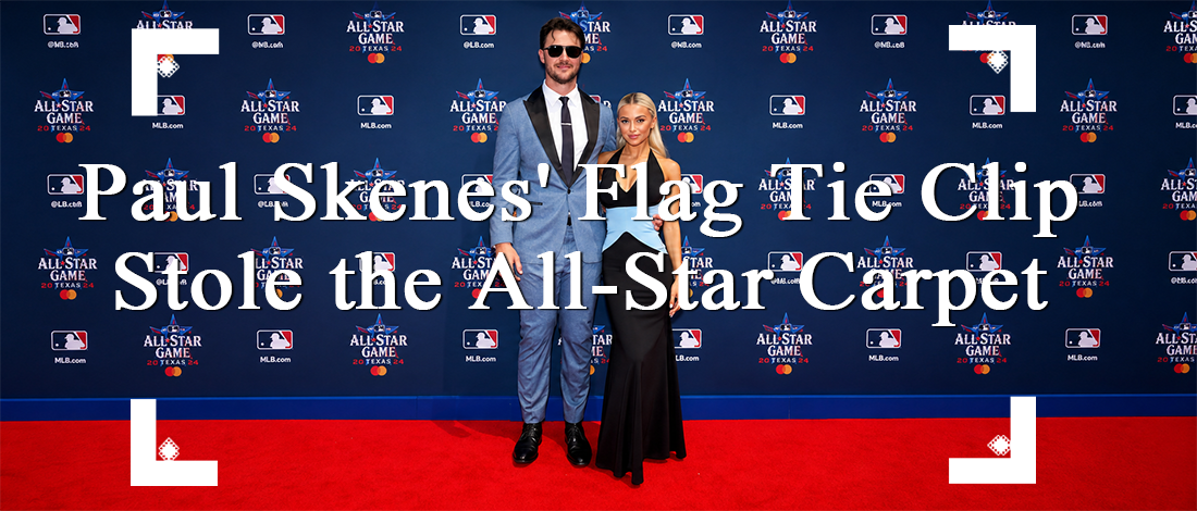 Paul Skenes wearing an American flag tie clip with a blue suit on the MLB All-Star red carpet