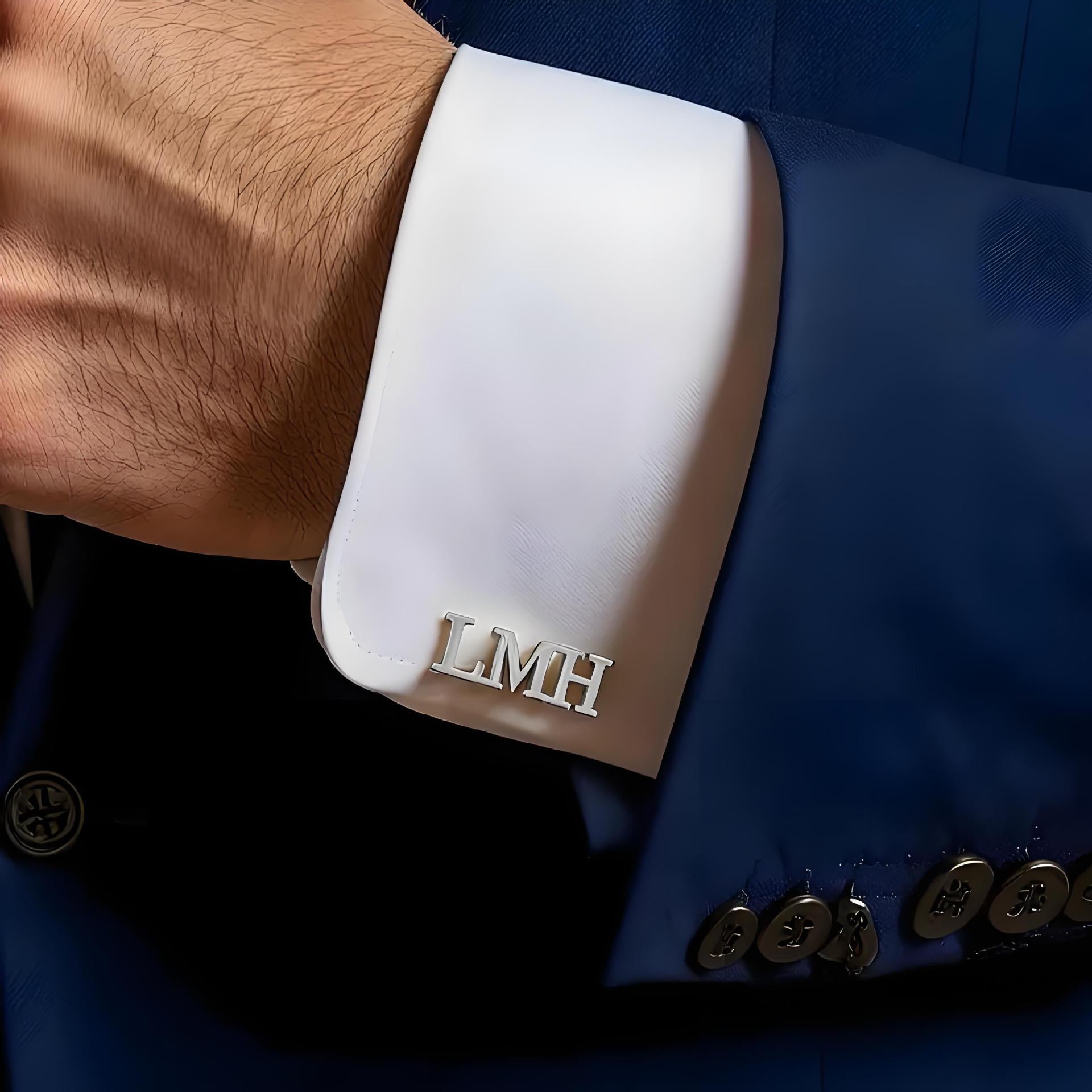 Silver finish 316L stainless steel custom initial cufflinks with LMH monogram displayed on a blue suit sleeve.