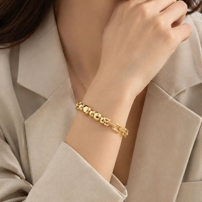 Shop a 6-piece sculptural bead chain bracelet set in gold or silver tones. Mix and match colors for a sleek, modern wholesale jewelry collection.