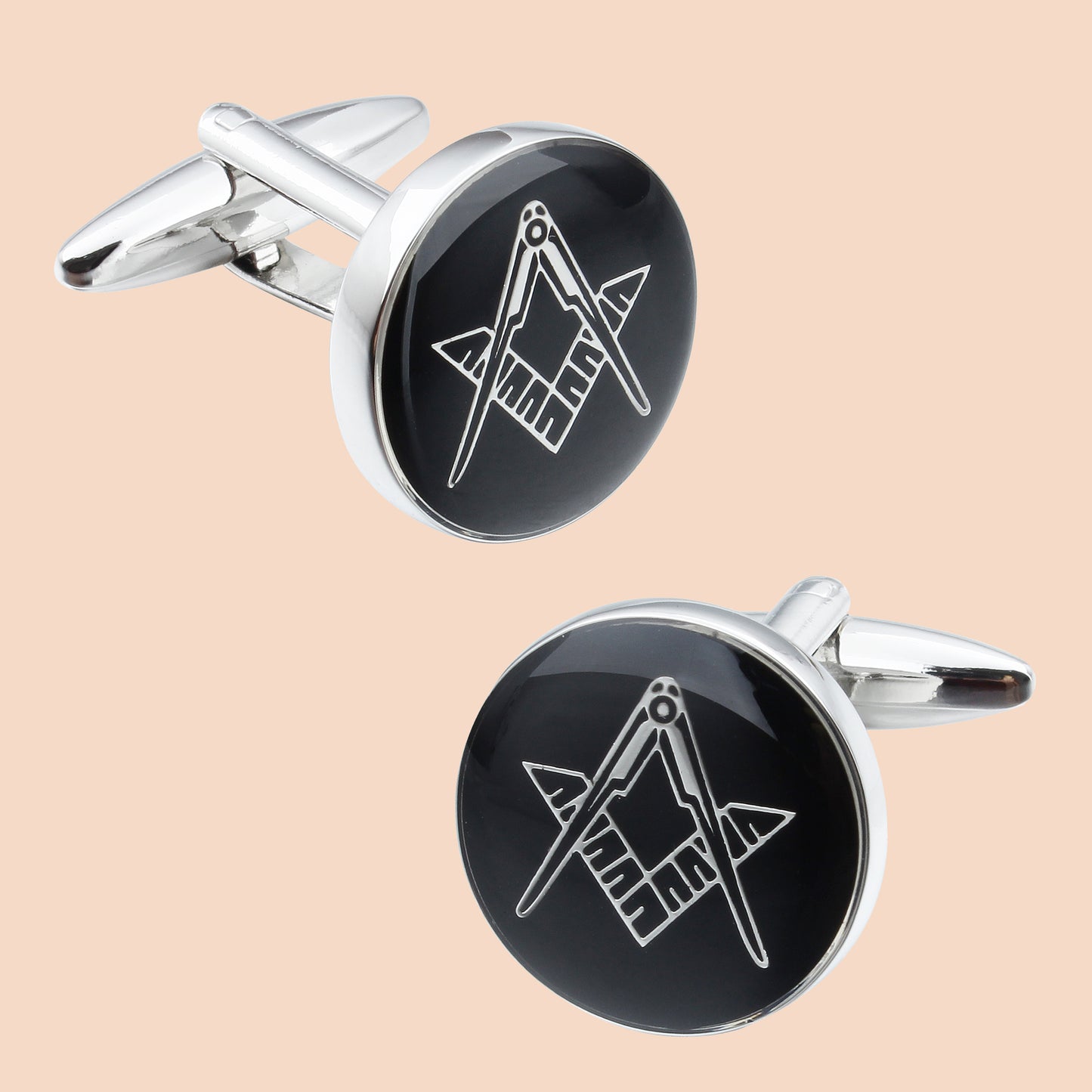 The set features the iconic Masonic Square and Compasses symbol, engraved in white on a glossy black background, framed by polished silver-toned metal.