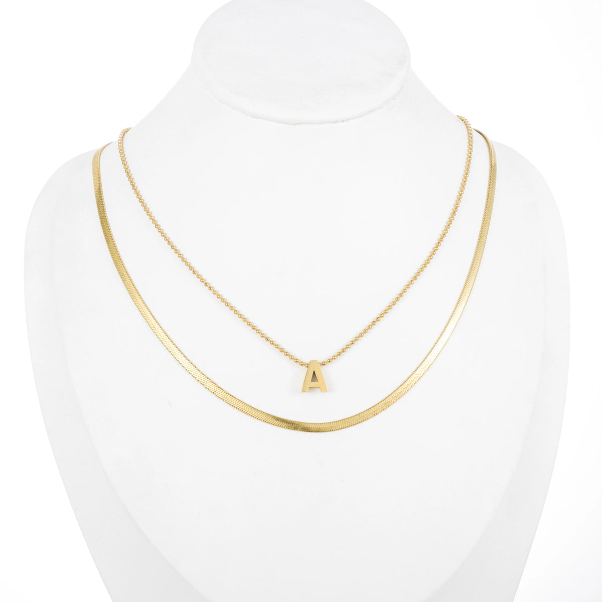 Dainty gold-tone layered necklace sets featuring delicate chains, pendants, and charms. Choose from multiple styles for an effortless stacked look.