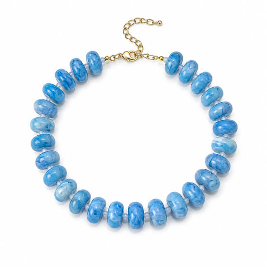 Shop a 6-color resin bead bracelet set in red, orange, yellow, green, blue and purple. Glossy translucent rondelle beads with adjustable gold-tone chains.