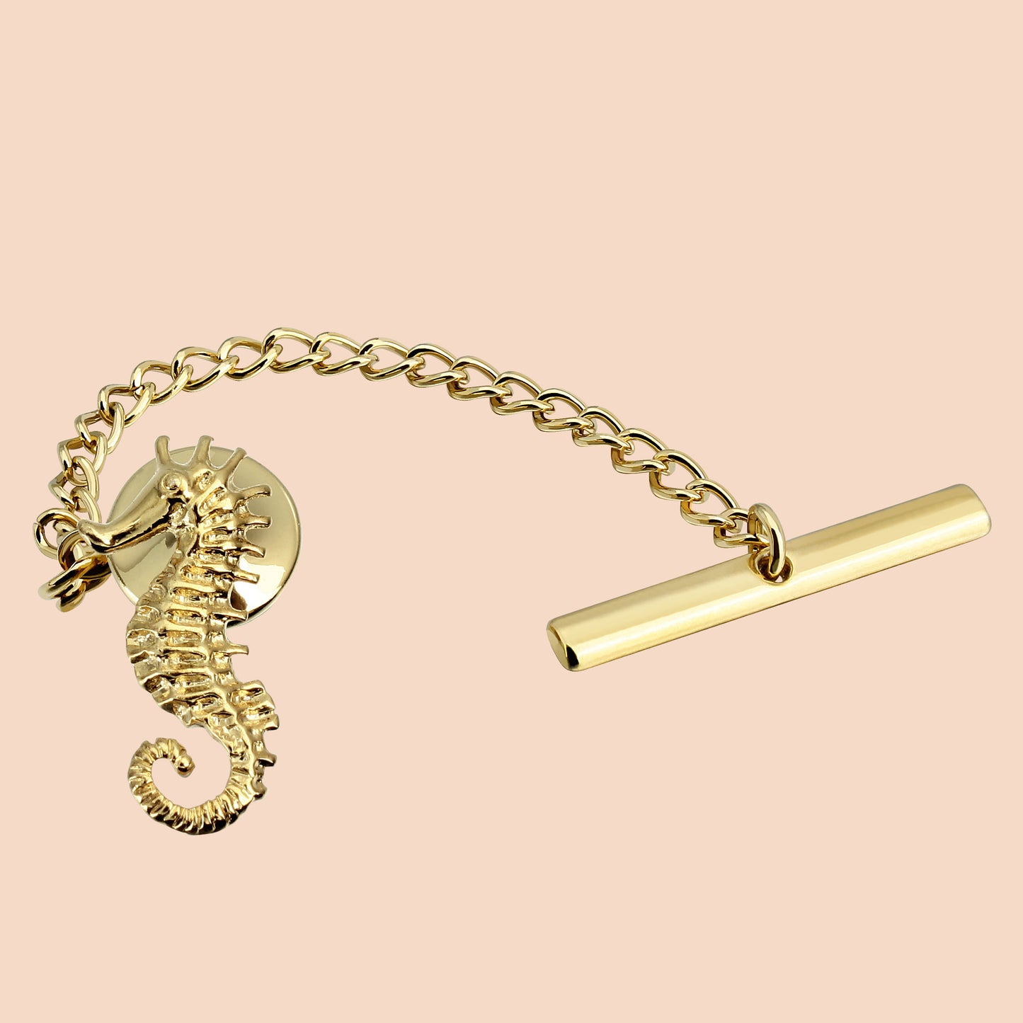 A gold-colored seahorse-shaped tie tack with a chain and a metallic clasp.