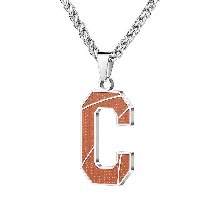 A curated collection of basketball-textured initial letter necklaces designed for wholesale buyers. Featuring a detailed basketball-grain finish on a stainless steel pendant and matching chain. 