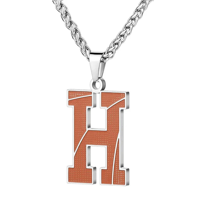 A curated collection of basketball-textured initial letter necklaces designed for wholesale buyers. Featuring a detailed basketball-grain finish on a stainless steel pendant and matching chain. 