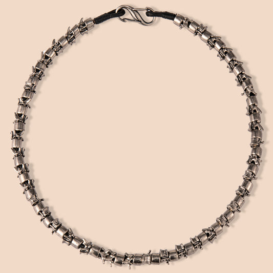 HAWSON antique barrel necklace with stainless steel vertebrae links, blending Victorian medical aesthetics and industrial machinery textures