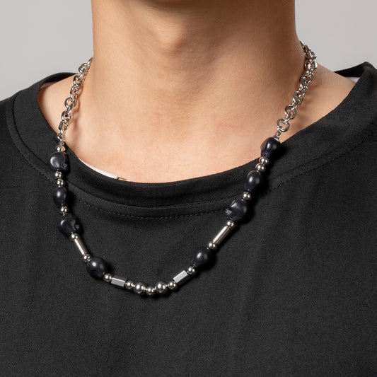 Professional male model wearing a black top with a HAWSON gothic black and stainless steel bead necklace