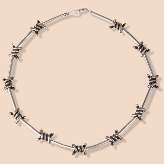 HAWSON gothic bike chain necklace with barbed wire accents and distressed stainless steel finish, blending motorcycle culture with punk aesthetics