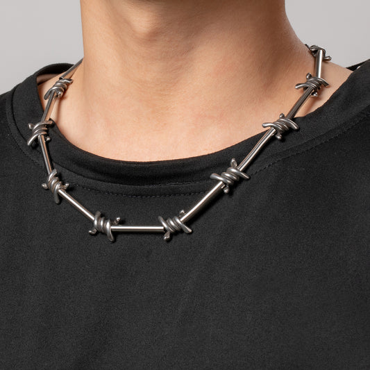 Professional male model wearing a black top and the HAWSON Locomotive Necklace