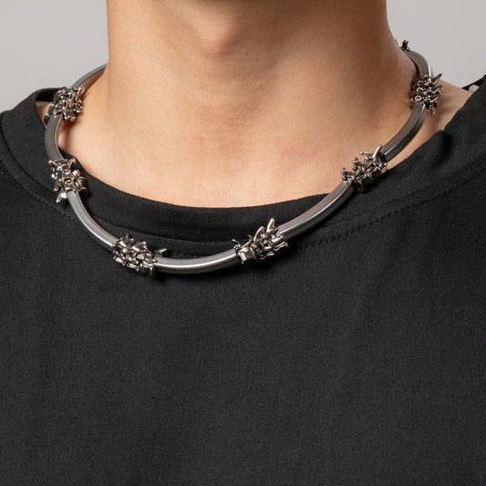 Male model wears HAWSON vertebrae chain Necklace on a black top.