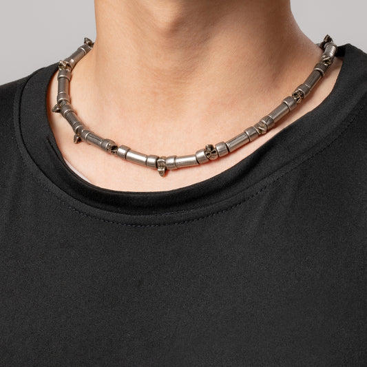 Professional male model wearing a black top with a HAWSON vintage cylinder links skull 